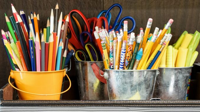 assorted color pencils in yellow bucket