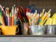 assorted color pencils in yellow bucket